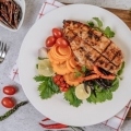 chicken-steak-with-lemon-tomato-chili-carrot-white-plate
