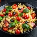 plate-pasta-with-cherry-tomatoes-olives-basil